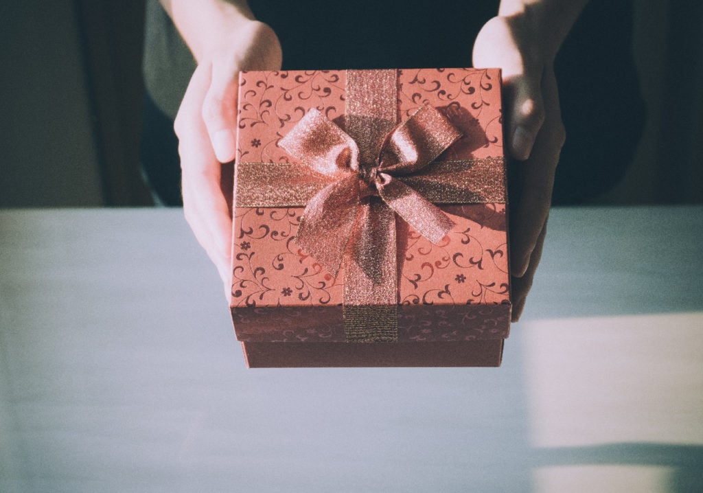 Close up of woman hands holding red gift box for special event